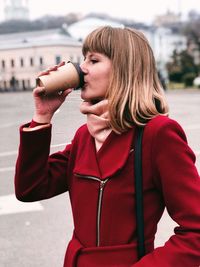 Woman drinking coffee in city