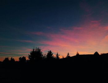 Silhouette of trees against sky at sunset