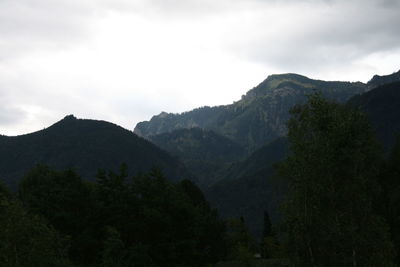 Scenic view of mountains against cloudy sky