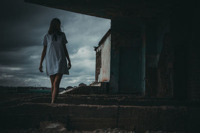 Rear view of woman standing against sky