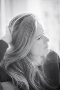 Close-up portrait of young woman looking away