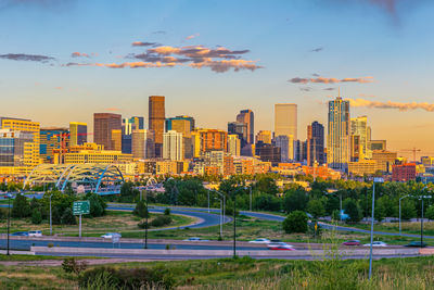 Buildings in city against sky during sunset