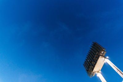 Low angle view of communications tower against building