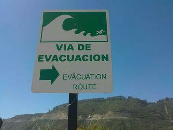 Information sign against blue sky