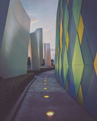 Road amidst buildings against sky