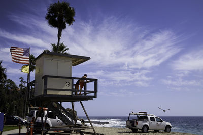 Lifeguard hut on beach against sky