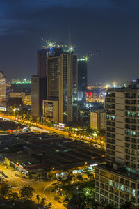 High angle view of illuminated buildings against sky at night