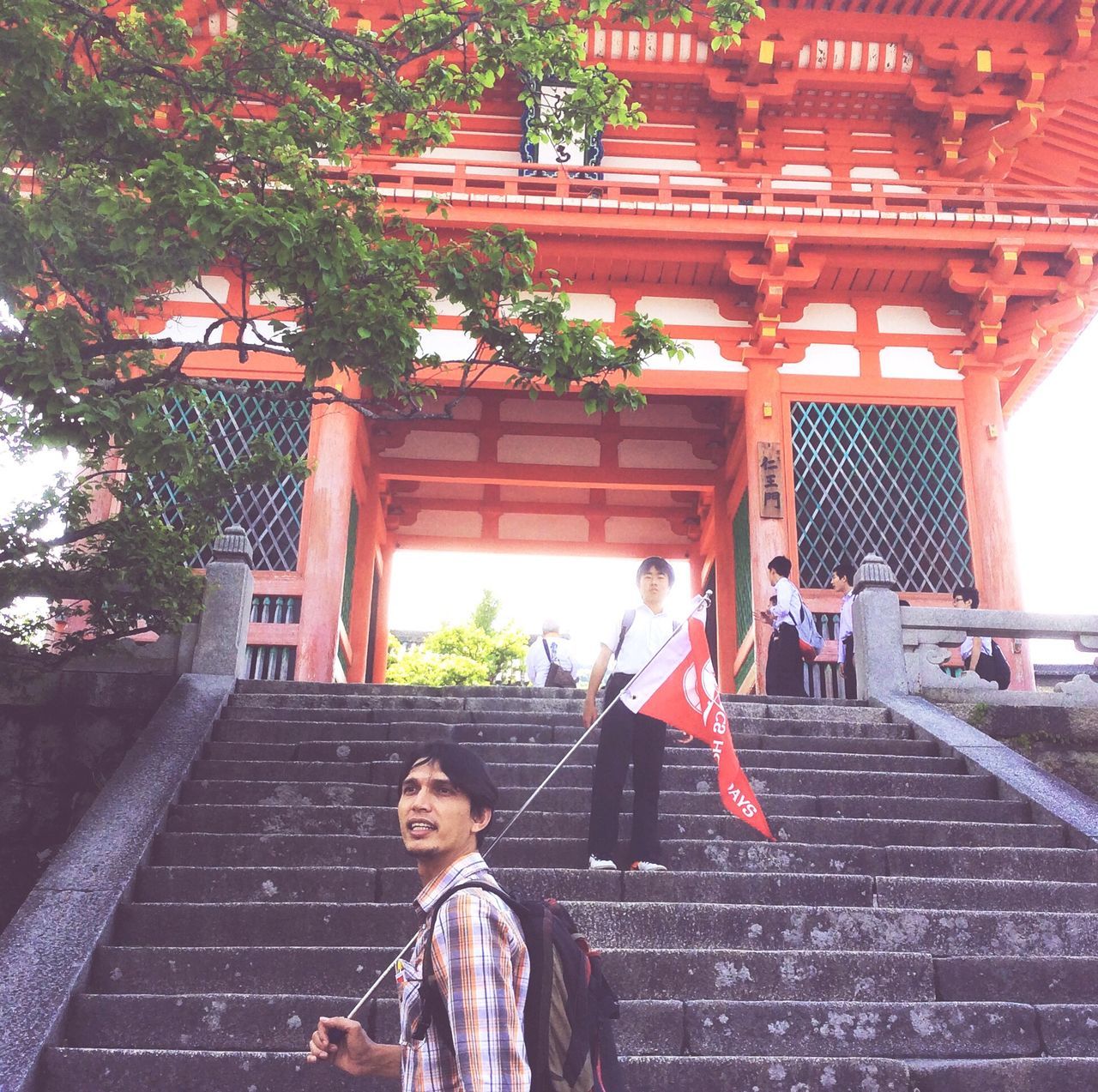 architecture, built structure, steps, building exterior, real people, outdoors, day, tree, lifestyles, standing, men, young adult, young women, one person, people