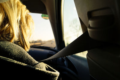 Rear view of woman sitting in car