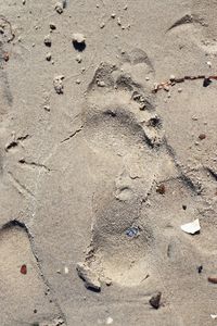 High angle view of footprints on sand