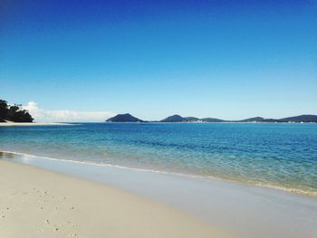 Scenic view of sea against clear blue sky