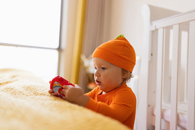 Cute baby playing with toy at home