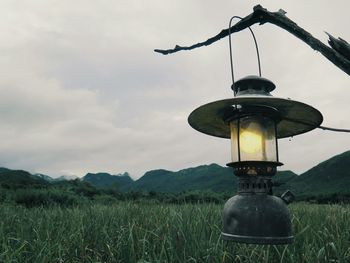 Street light on field against sky