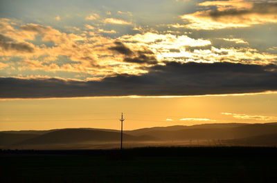 Scenic view of field against sky during sunset