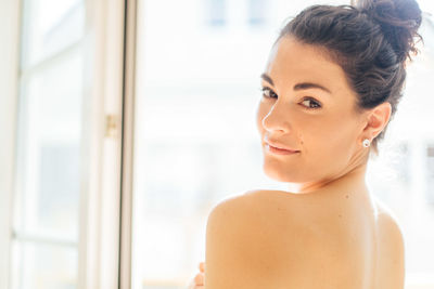 Close-up portrait of shirtless young woman