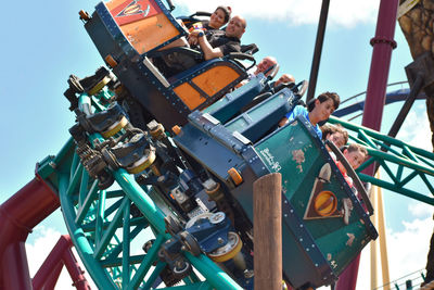 Low angle view of chain swing ride against sky