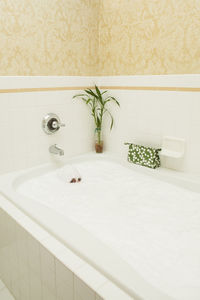 Portrait of woman taking bath in bathtub at home