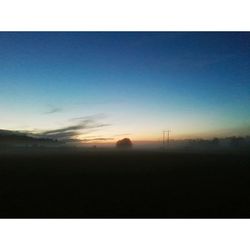 Scenic view of field against sky at sunset