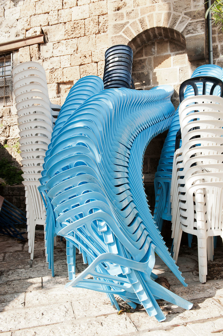 STACK OF CHAIRS ON BEACH