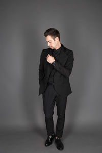 Young man looking away against white background