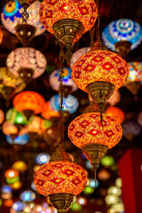 Close-up of illuminated lanterns hanging at night