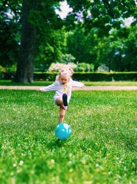 Full length of boy playing with ball