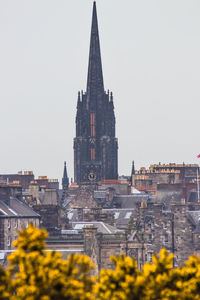 Buildings in city against clear sky