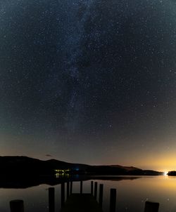 Scenic view of lake against star field at night