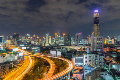 High angle view of illuminated buildings against sky at night