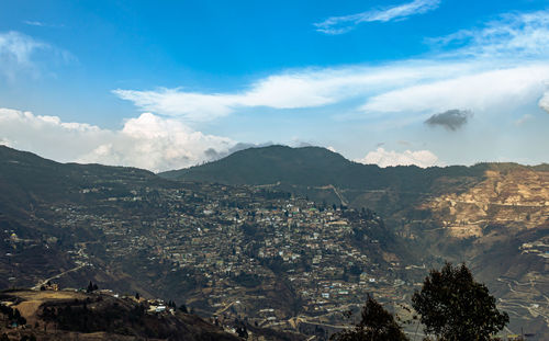 City urbanization view from hilltop with huge construction and dramatic sky