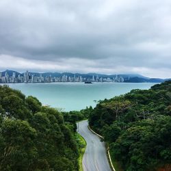 Scenic view of river by trees against sky