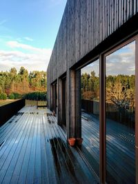 View of trees by built structure against sky