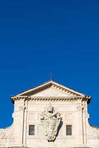 Low angle view of building against clear blue sky