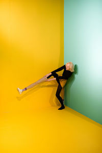 Full length of man against yellow background
