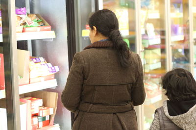 Side view of woman shopping in super market
