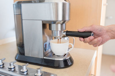 Close-up of hand holding coffee cup