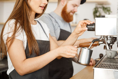 Midsection of woman holding coffee cup