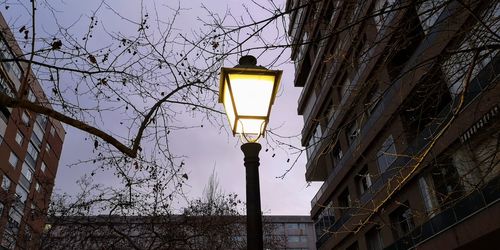 Low angle view of street light against building