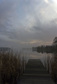 Scenic view of pier over lake against sky