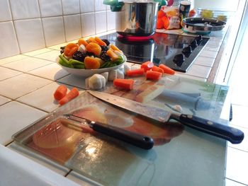 High angle view of fruits and vegetables on cutting board at home