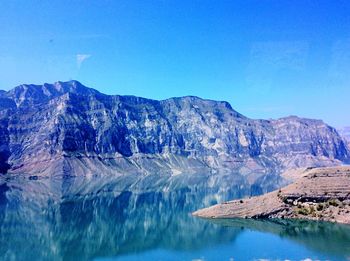 Scenic view of dramatic landscape against blue sky