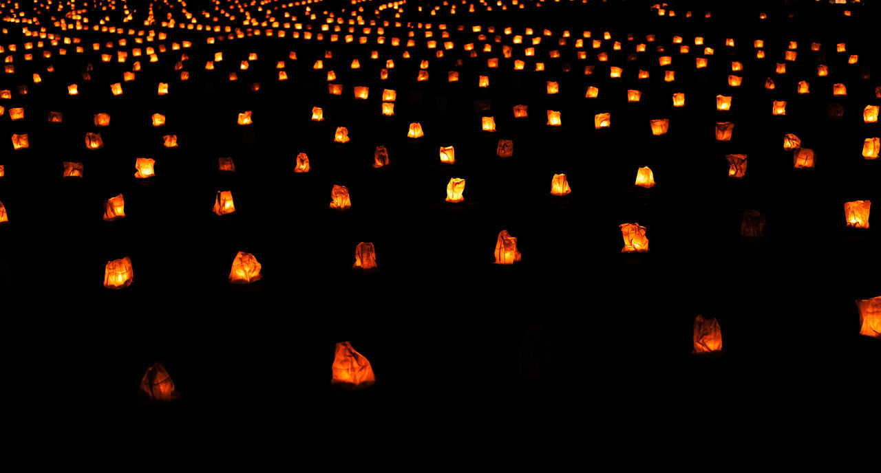 font, large group of objects, illuminated, lighting equipment, no people, in a row, night, abundance, darkness, orange color, tradition, lantern