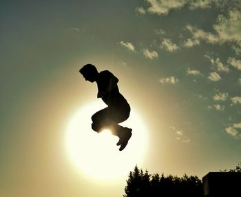 Low angle view of silhouette people at sunset