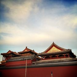 High section of pagoda against cloudy sky