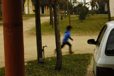 Blurred motion of man on road amidst trees