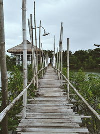 View of bridge over calm sea against sky