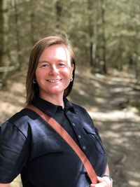 Portrait of smiling woman in forest