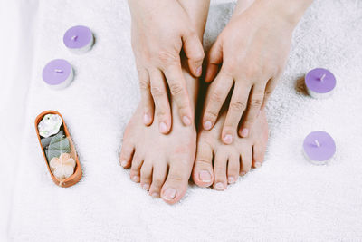 Low section of woman on towel during spa treatment