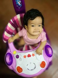 Portrait of cute boy playing with toy at home