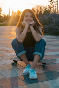 Portrait of smiling young woman sitting outdoors